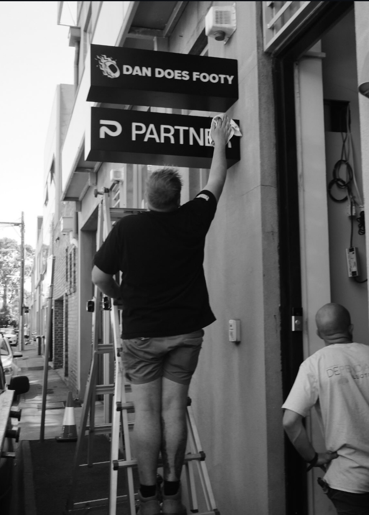 Shopfront sign installation — Dan Does Footy